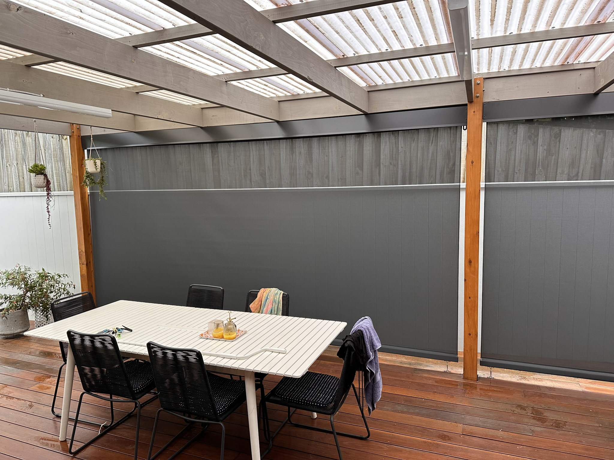 Outdoor mesh blinds enclosing a residential outdoor dining area